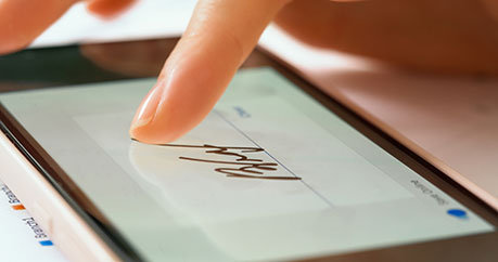 Sign On The Dotted Line Blog Post image showing a person signing a form on a tablet using their finger