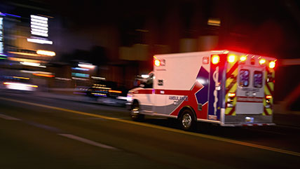 Ambulance rolling down the road with the sirens on