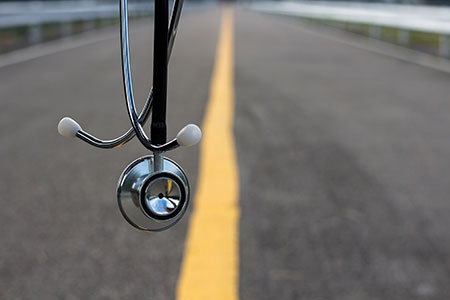 A background of a street with a stethoscope hanging close to view