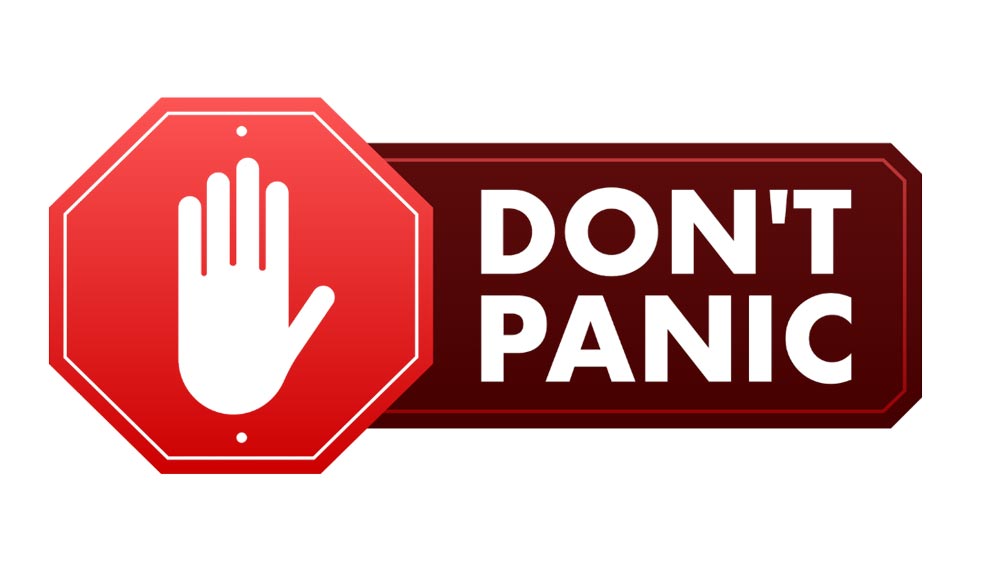 A red octagonal stop sign icon with a white outstretched hand symbol, placed to the left of a dark red rectangular sign that reads "DON'T PANIC" in white, bold uppercase letters. Both signs have a subtle shadow effect.